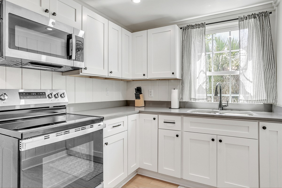 This light and bright kitchen makes meal prep a joy, with natural sunlight and cheerful details all around.