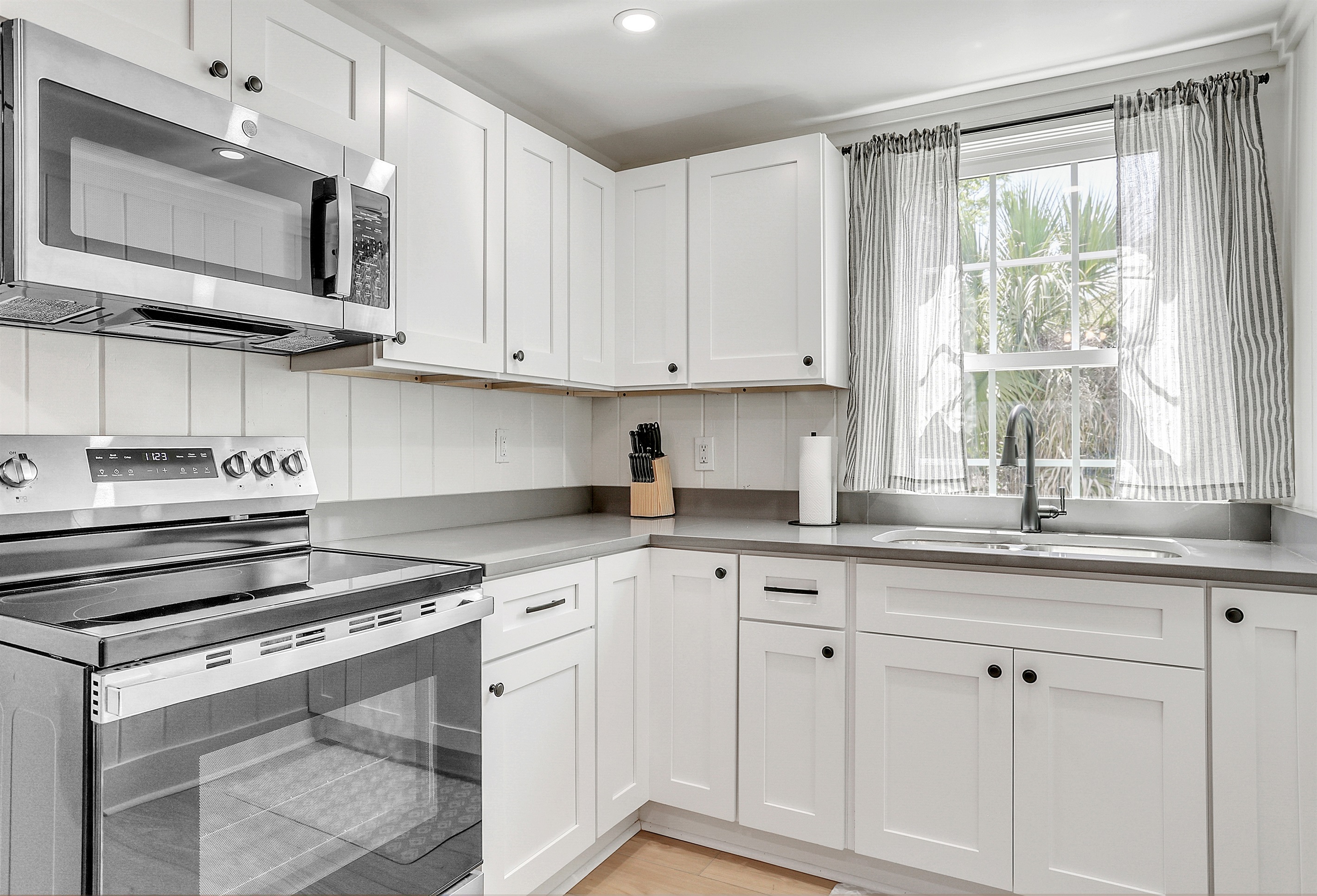 This light and bright kitchen makes meal prep a joy, with natural sunlight and cheerful details all around.