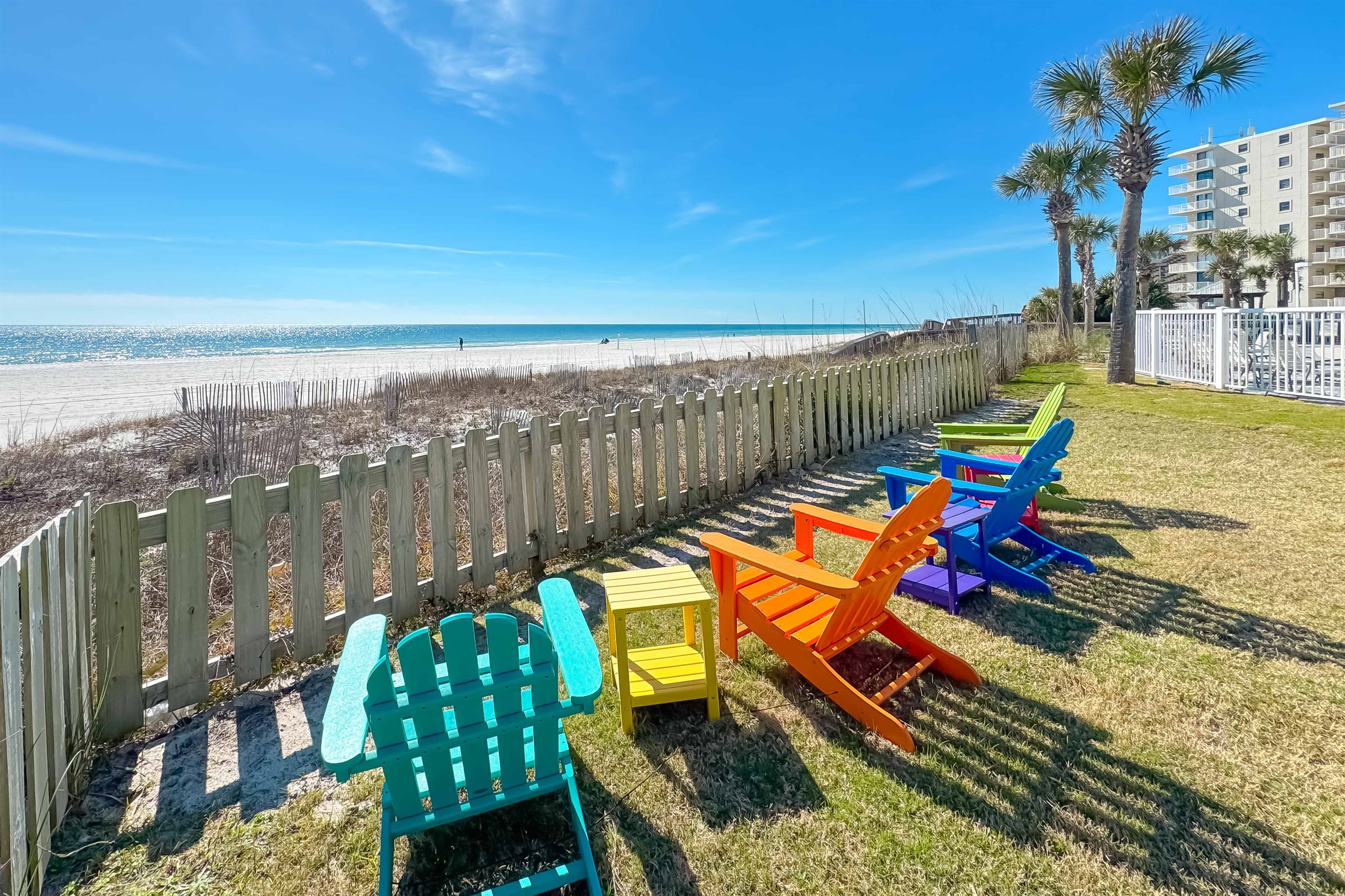 Gain a new perspective on coastal beauty with this panoramic view.  Witness the vastness of the beach and the shimmering sea.