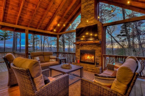 Covered deck with mountain views and stone fireplace at our Blue Ridge cabin