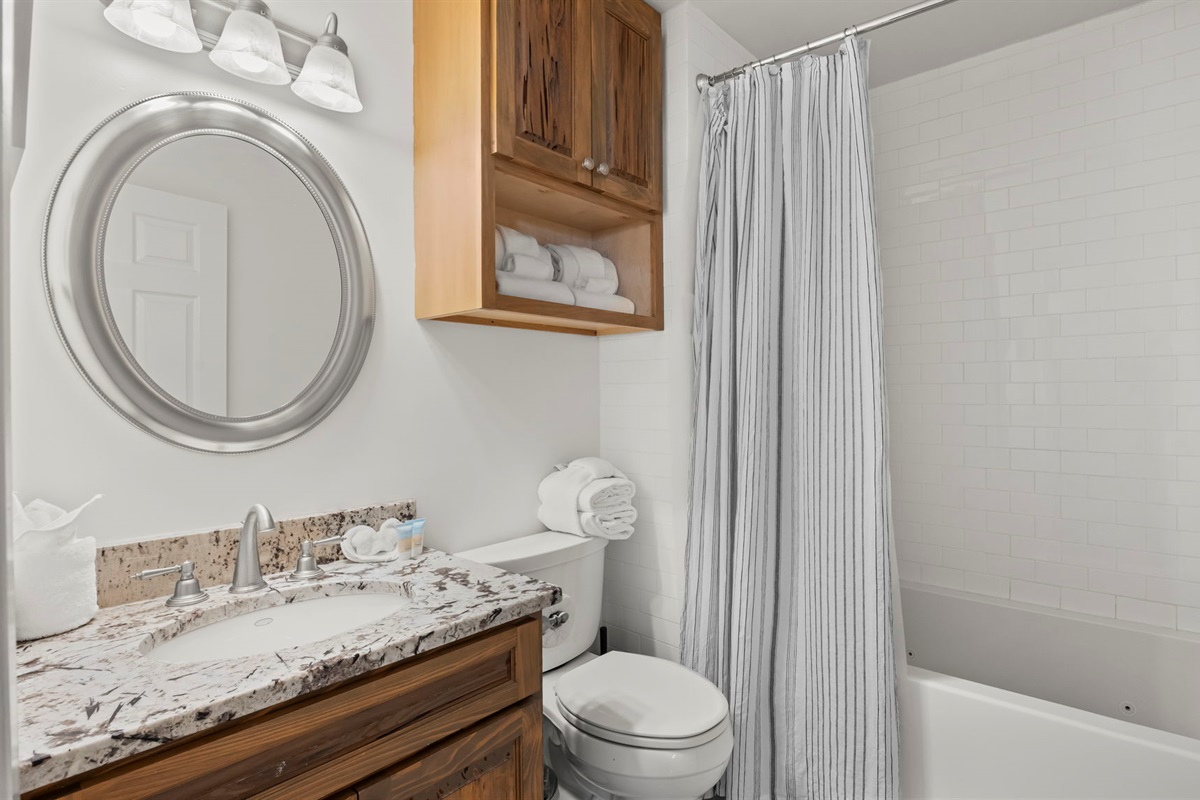 Guests can enjoy ultimate relaxation in the bathroom of our Cotton Bayou condo, featuring a luxurious Jacuzzi tub with air jets and continuous heat. Perfect for unwinding after a day of fun on the water or exploring the area.