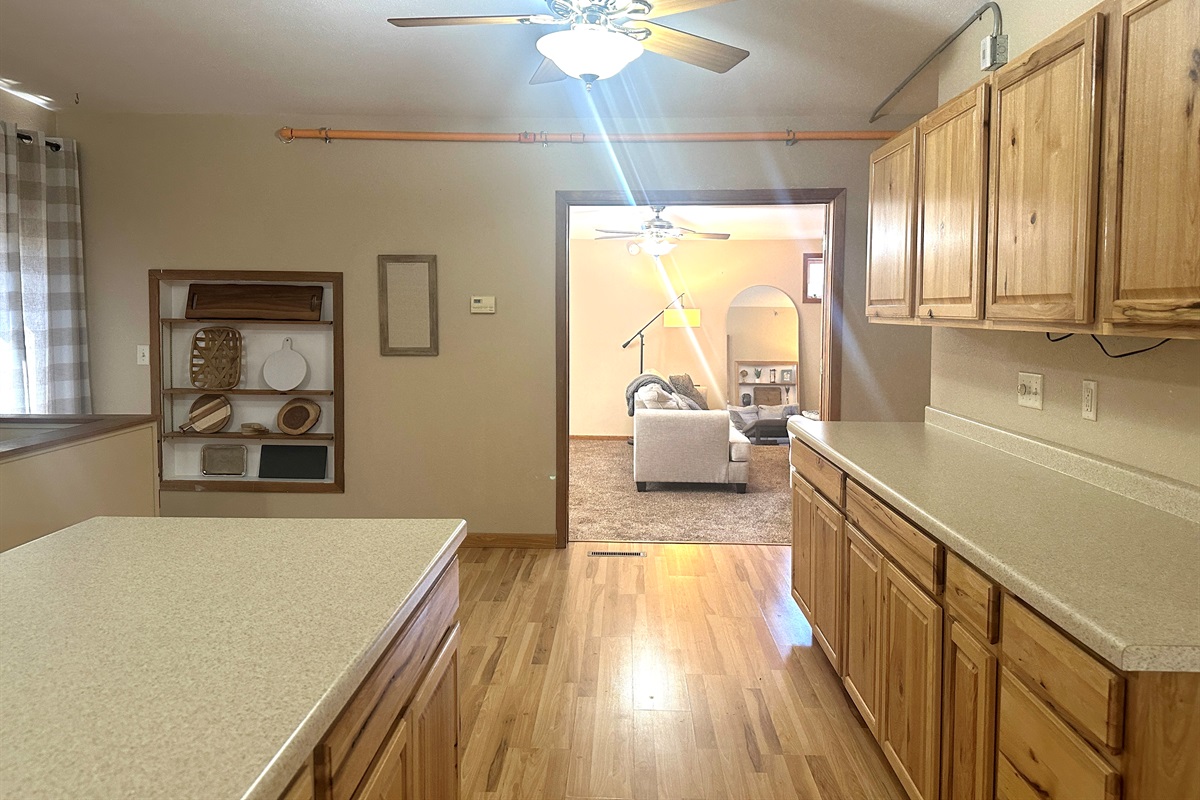 The large kitchen flows through double French doors into the living room.