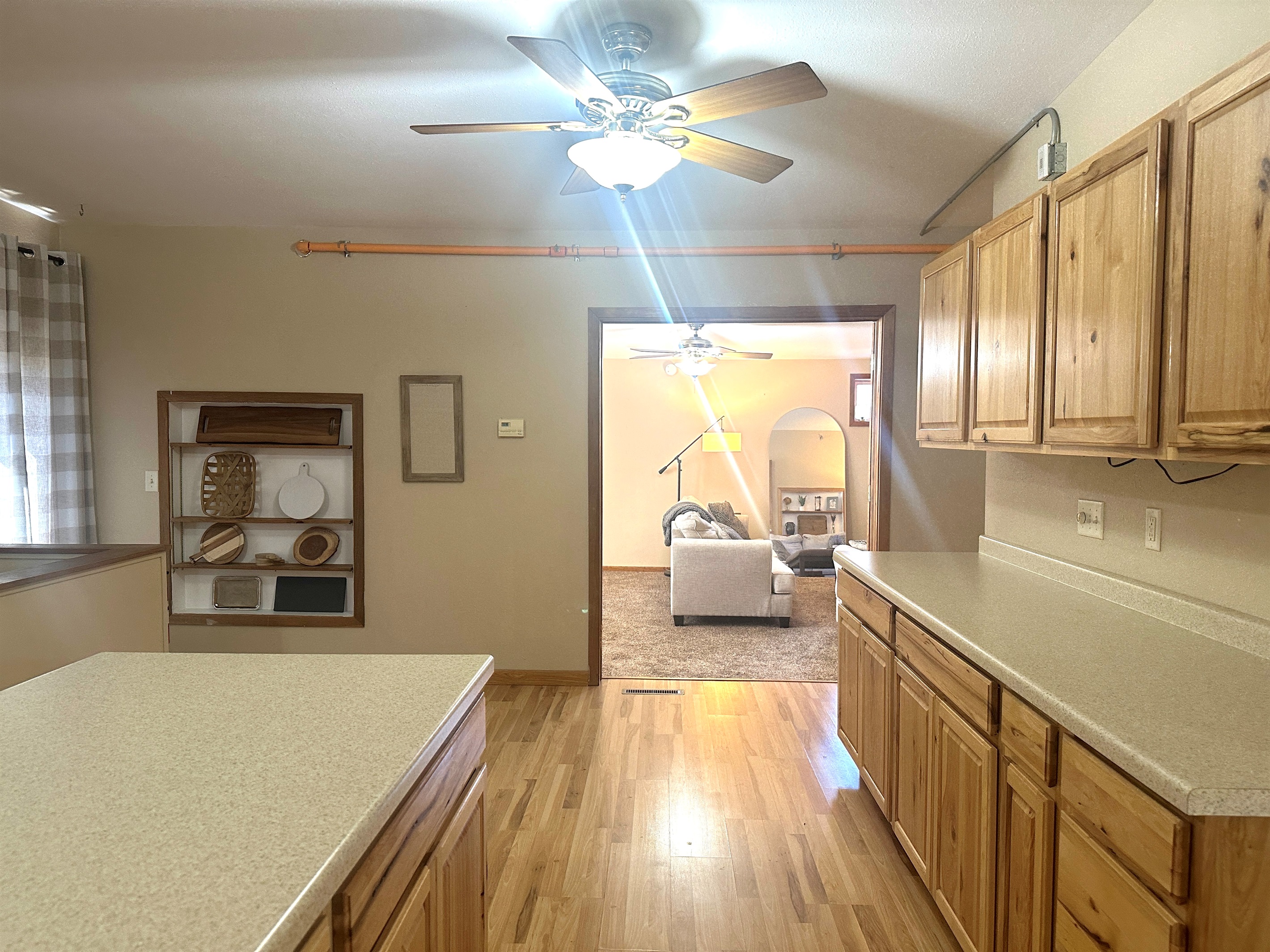 The large kitchen flows through double French doors into the living room.