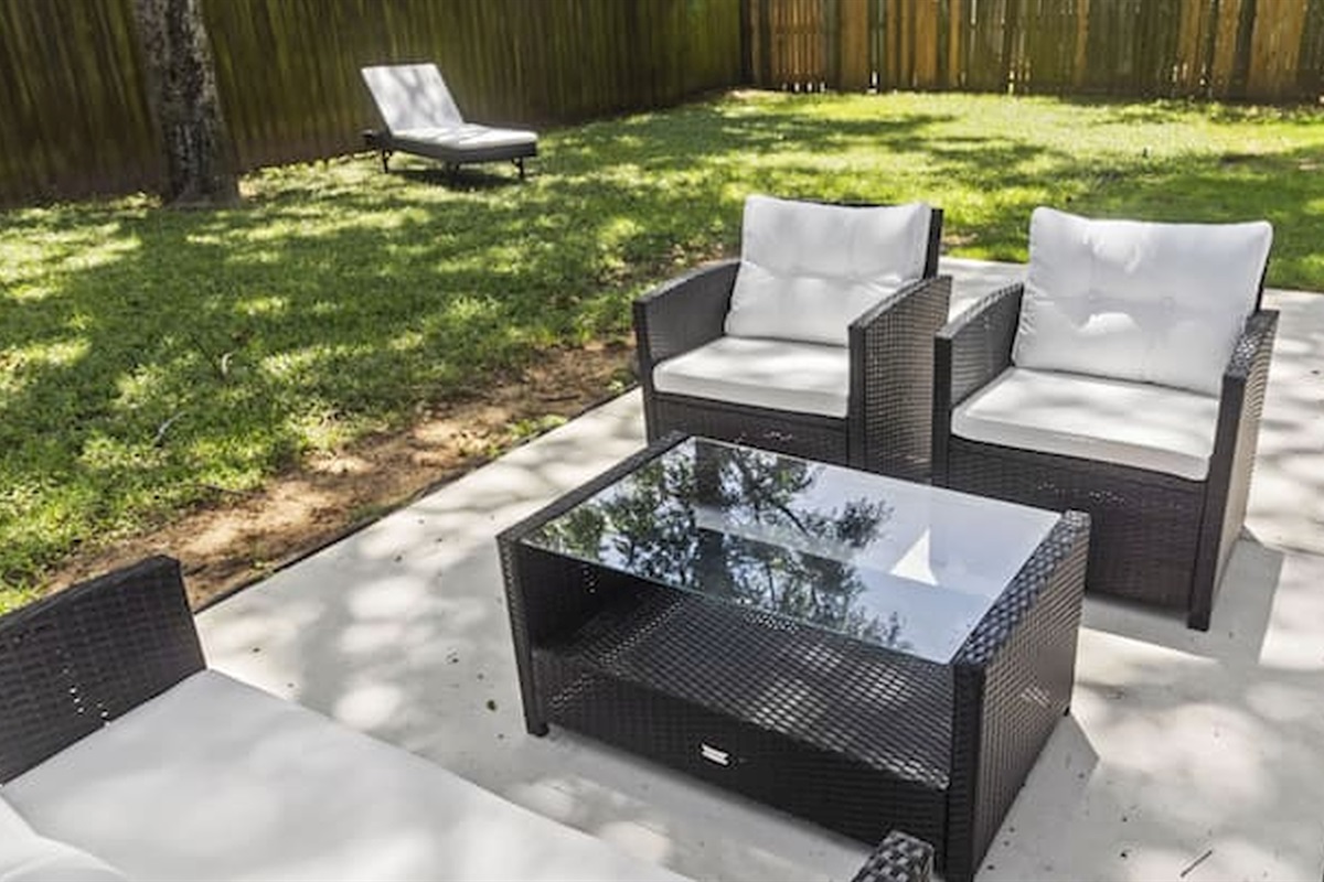 Relax outdoors with private patio seating surrounded by mature trees and greenery.