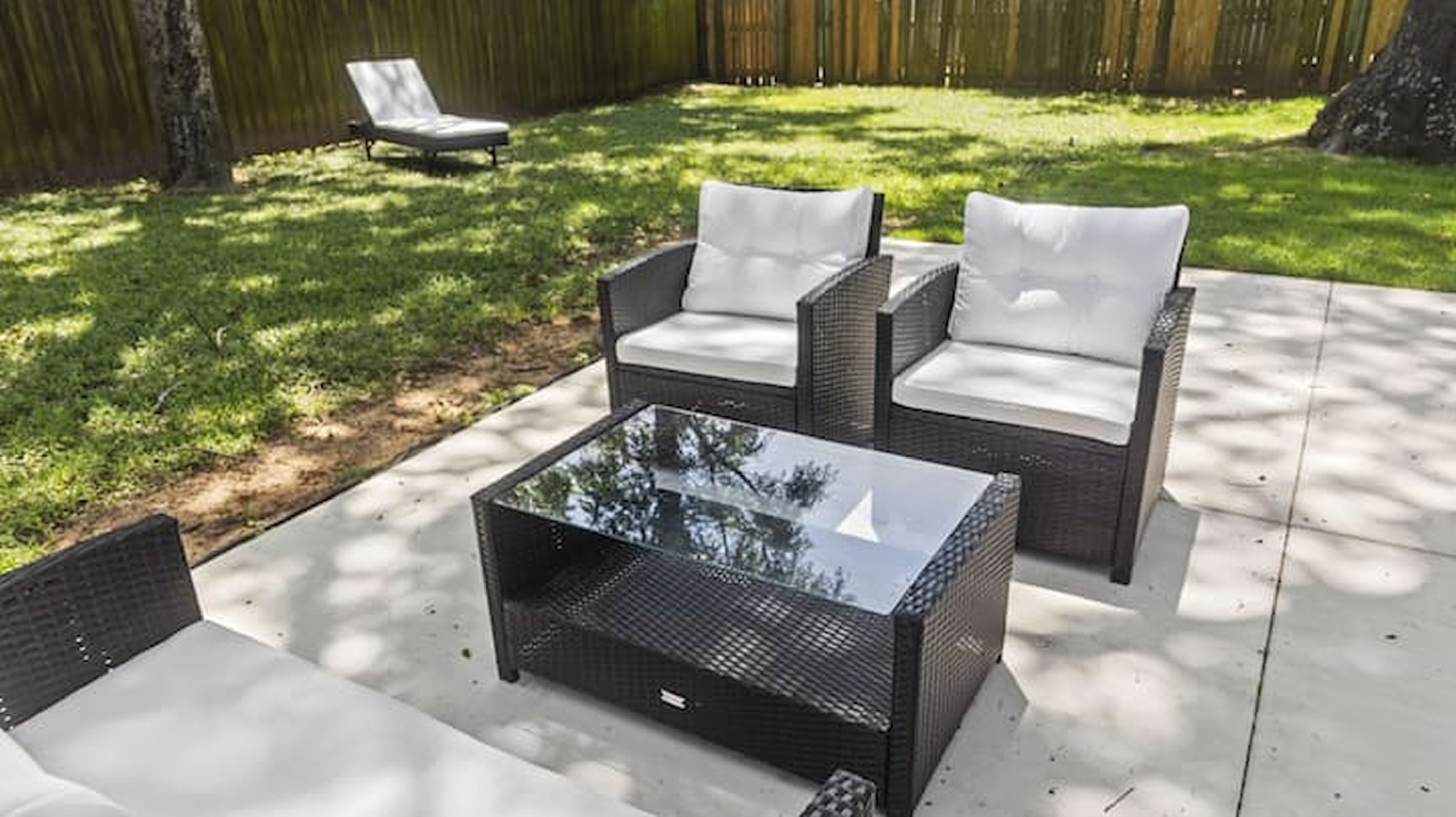 Relax outdoors with private patio seating surrounded by mature trees and greenery.