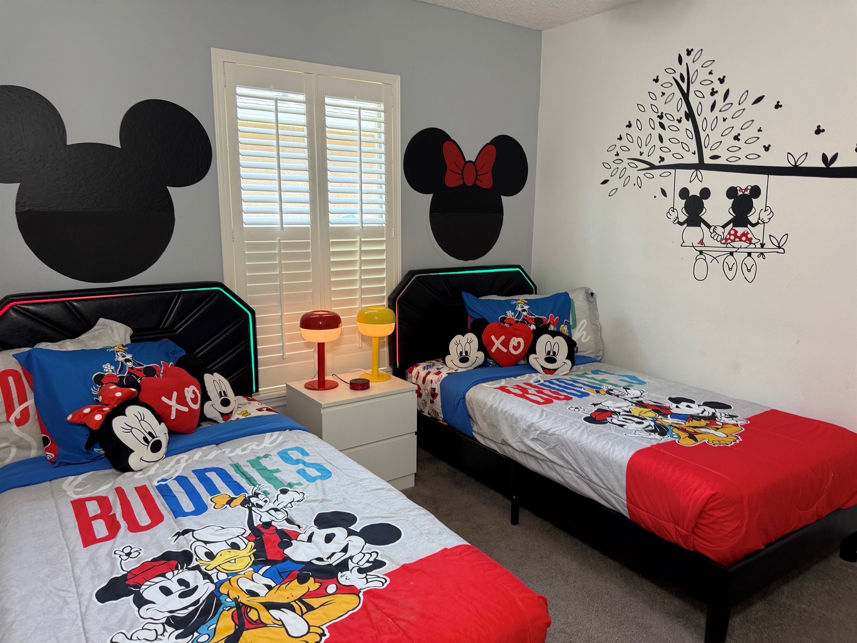 🐭✨ Fun for all ages in our Mickey Mouse-themed twin room! Featuring comfy twin beds and a 50” Smart TV for movies, games, and magical moments.