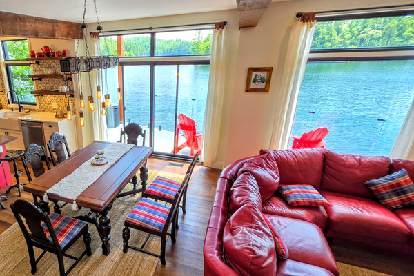 Dining room with adjacent kitchen and doors to balcony and hot tub