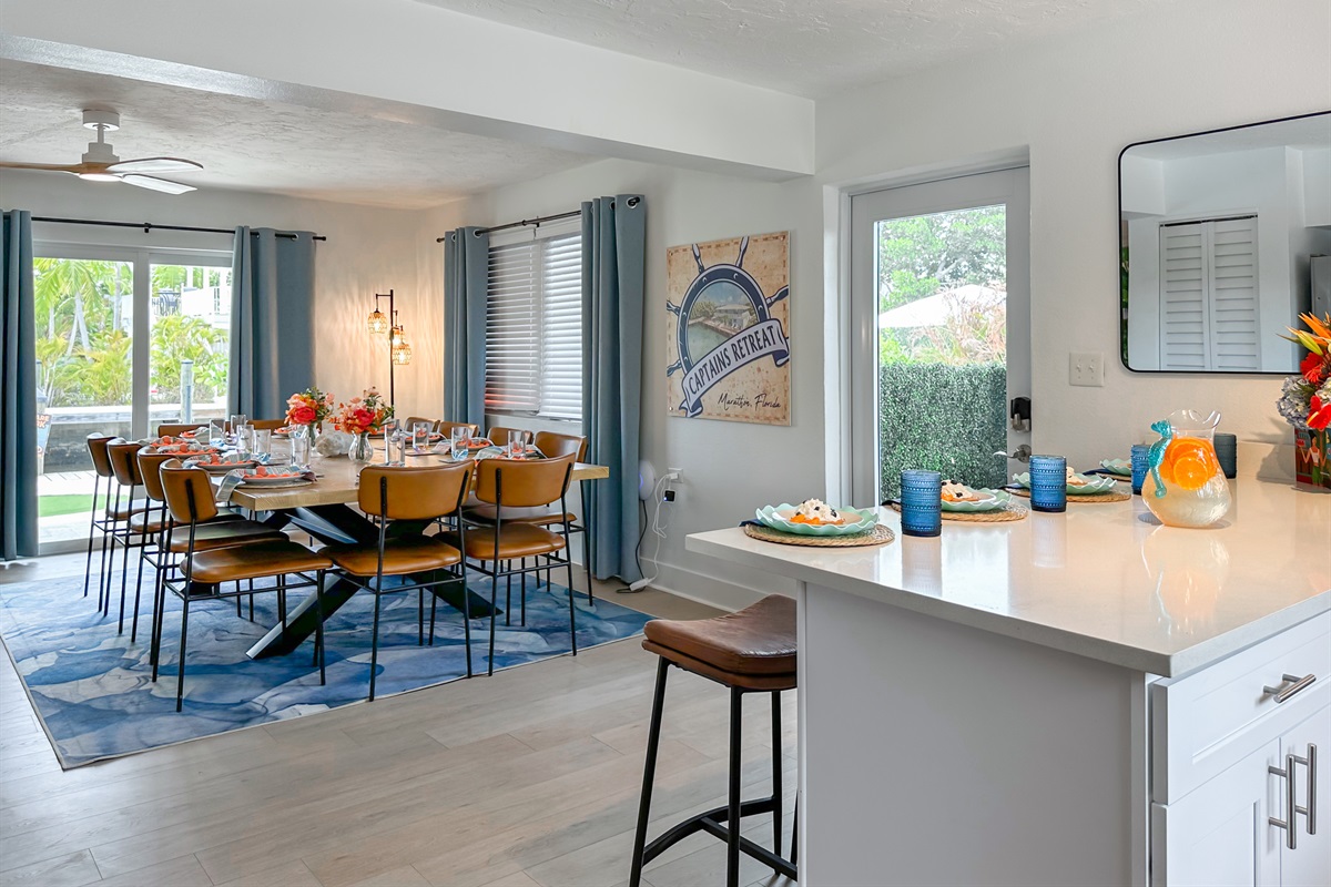 The sliding doors by the dining table open up to the canal side putting green and BBQ area.