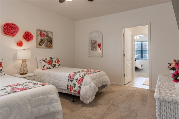 Upstairs Garden Room with two Twin XL Beds and extra comfy memory foam mattresses. Includes a 70 inch smart TV.  Luggage rack & laundry basket in closet.