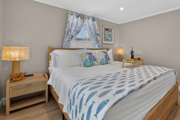 Rest and recharge in a peaceful bedroom with comfortable bedding and relaxing coastal décor.