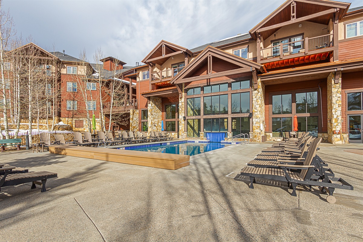 Outdoor pool area with plenty of seating