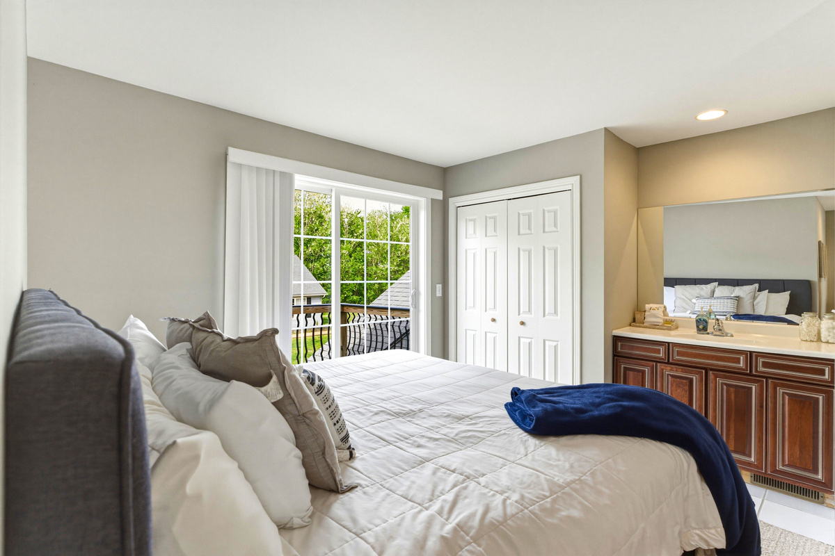2nd floor master with jacuzzi tub and small living room with couch and balcony
