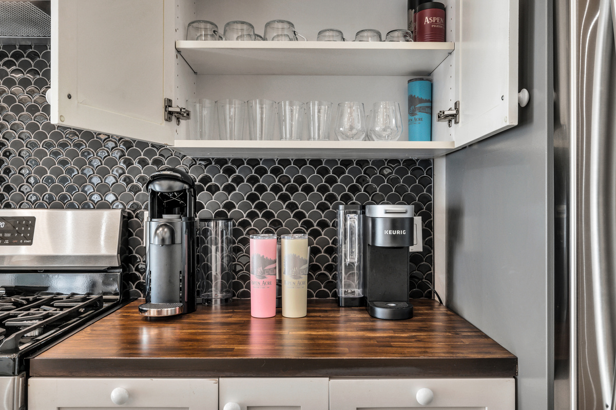 Start the morning your way at the coffee station, with plenty of mugs, glassware, and coffee ready for slow cabin mornings.
