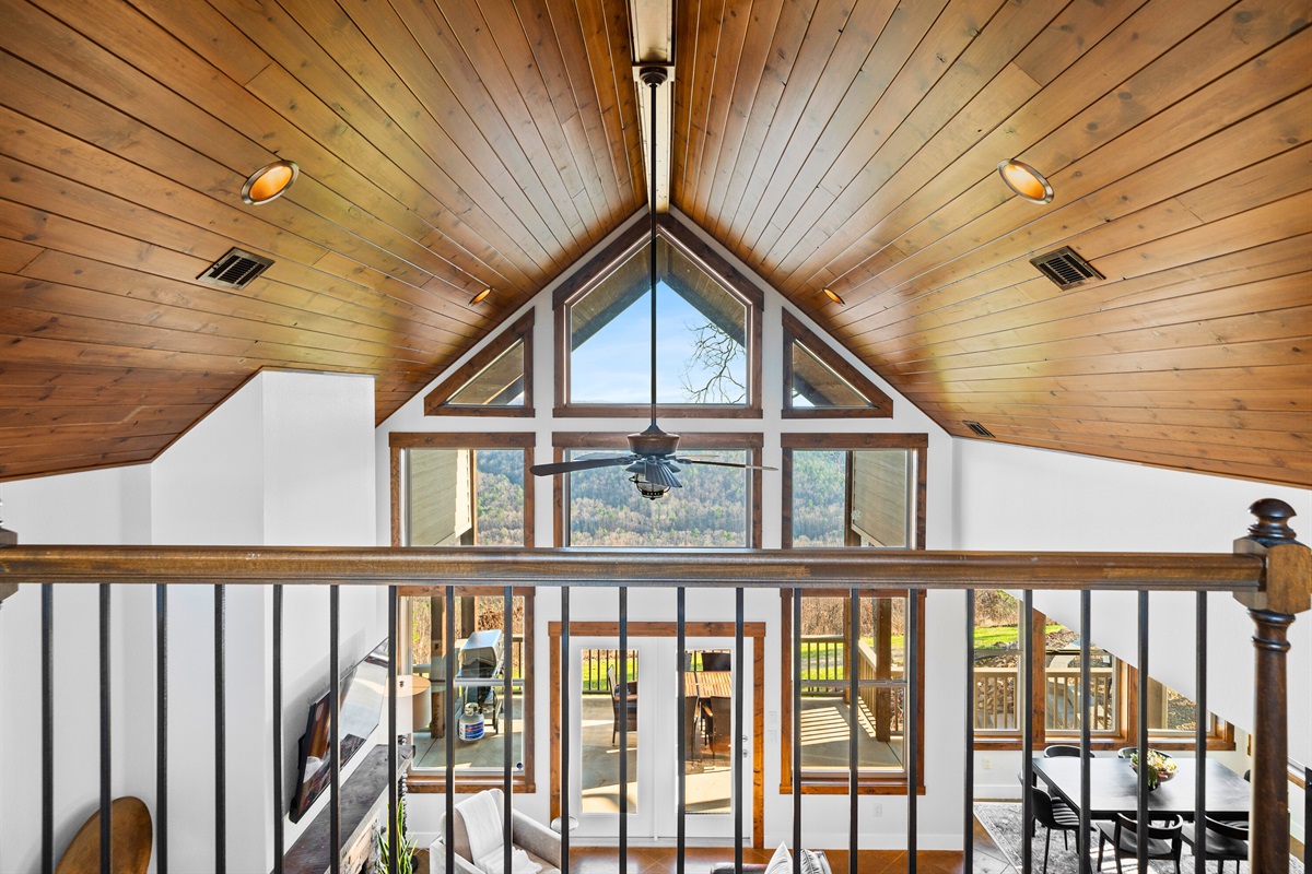 From the loft railing, you can look down into the great room and fully appreciate the impressive architecture and natural light.