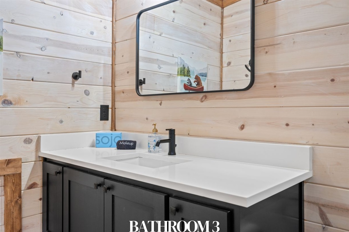 Bathroom 3: Bright vanity with rustic details.