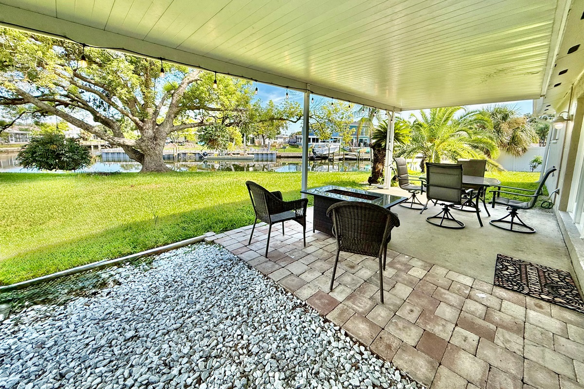 Surrounded by palms and greenery, this shaded patio provides a peaceful escape with all the comforts of indoor living—outside.