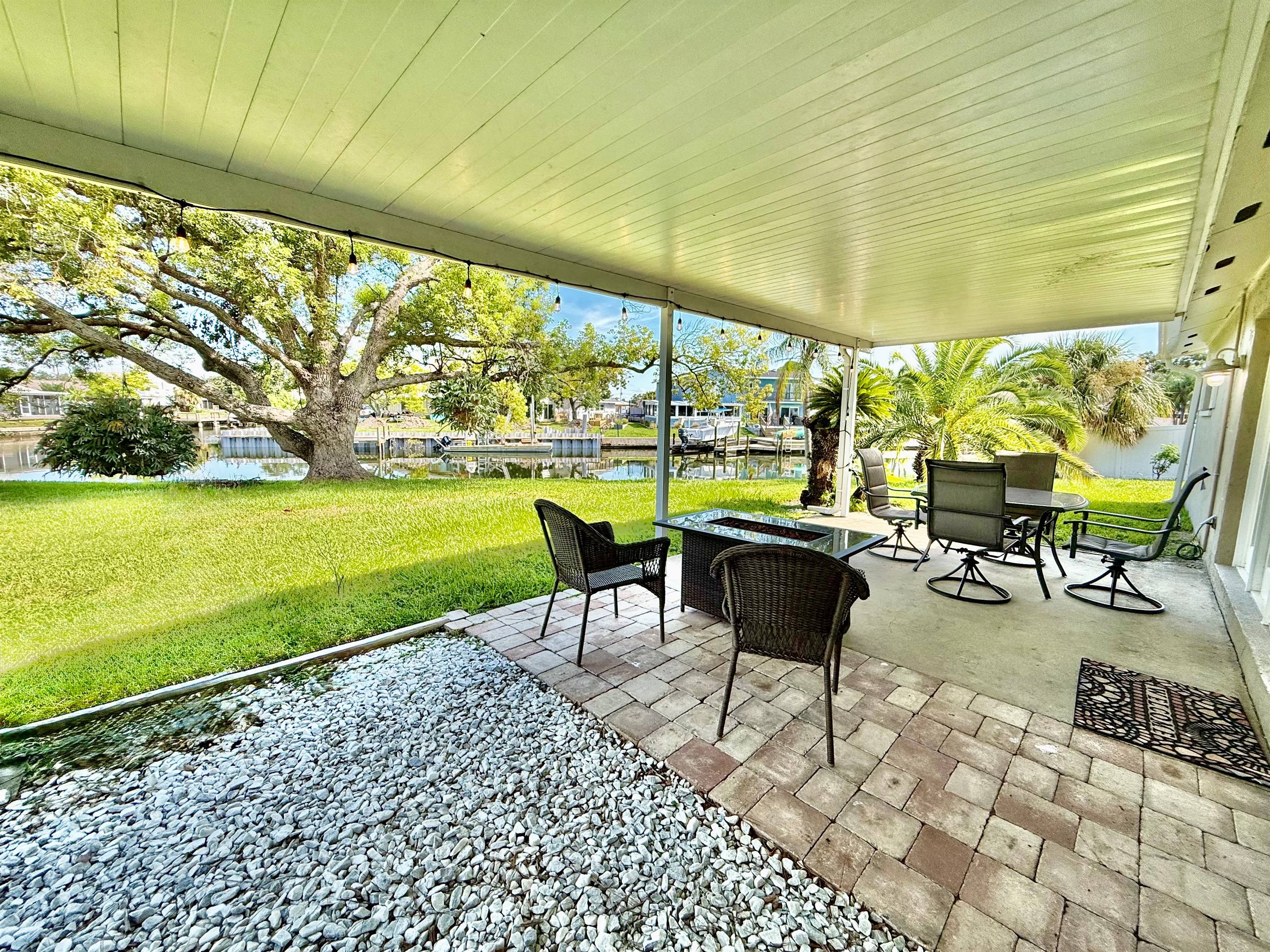 Surrounded by palms and greenery, this shaded patio provides a peaceful escape with all the comforts of indoor living—outside.