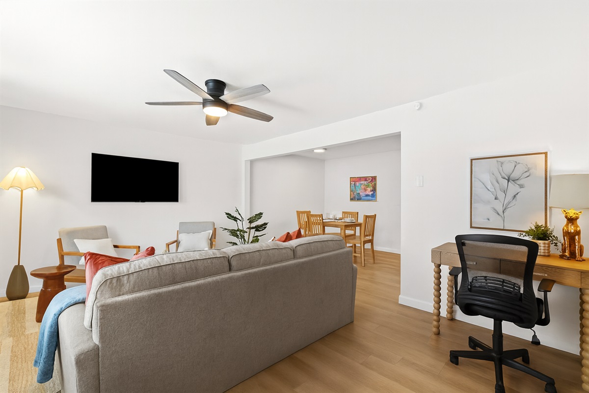 The desk setup sits conveniently between the living and dining areas for easy access and seamless flow.
