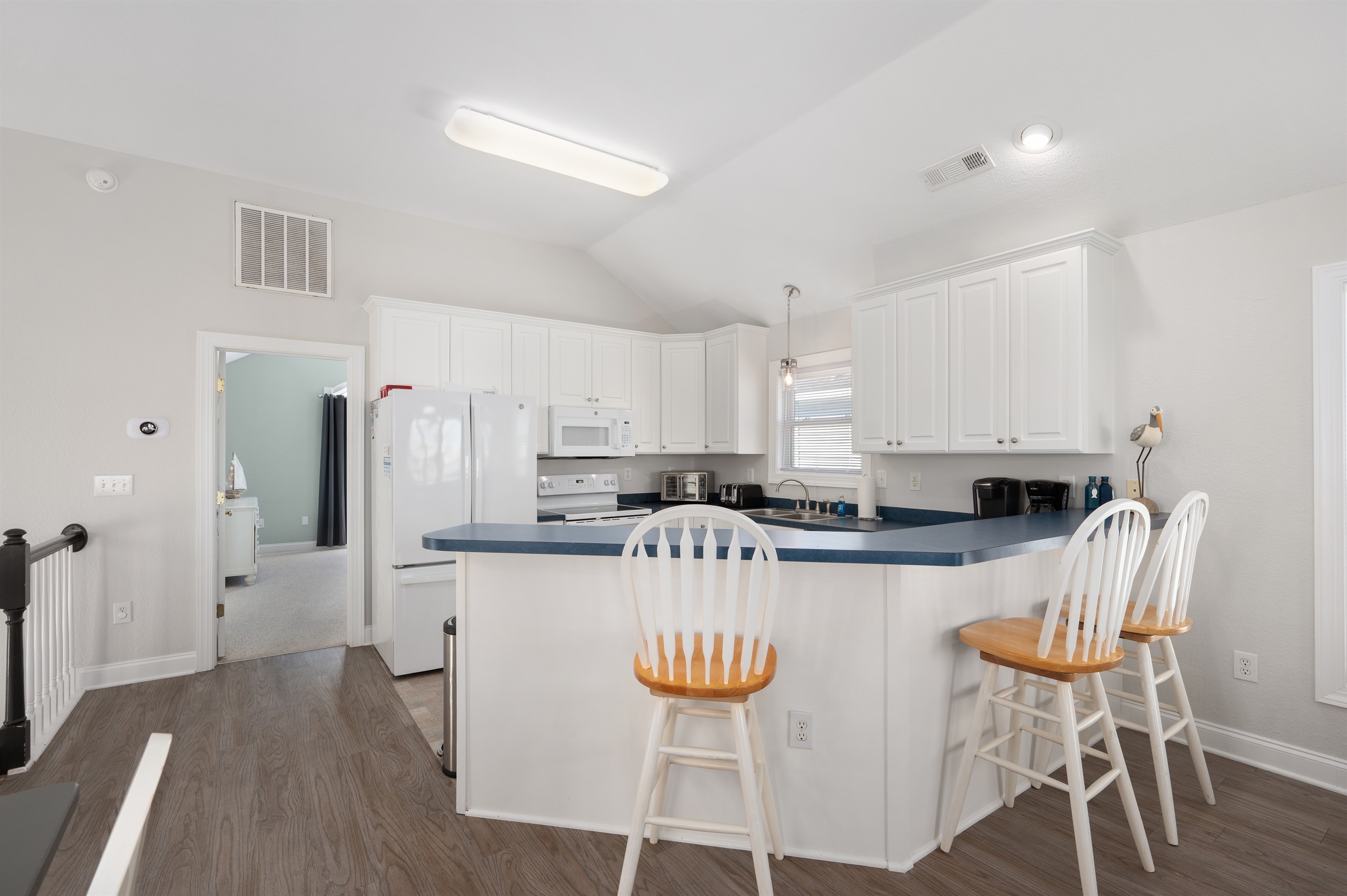 Bright, open kitchen with bar seating for four.