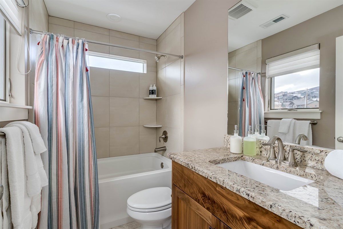 Private ensuite bath for bedroom 2 with clean, modern design