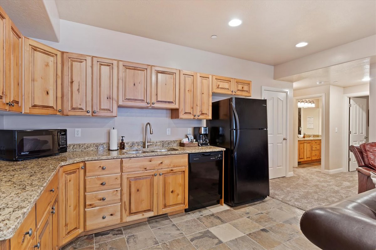 Another view of the lower kitchen showcases its thoughtful layout and abundant storage, making meal prep effortless.