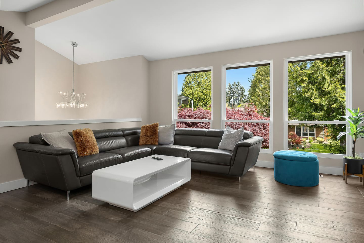 “Relax in this elegant living area featuring a large smart TV and a beautiful fireplace—creating the perfect blend of comfort and sophistication.”