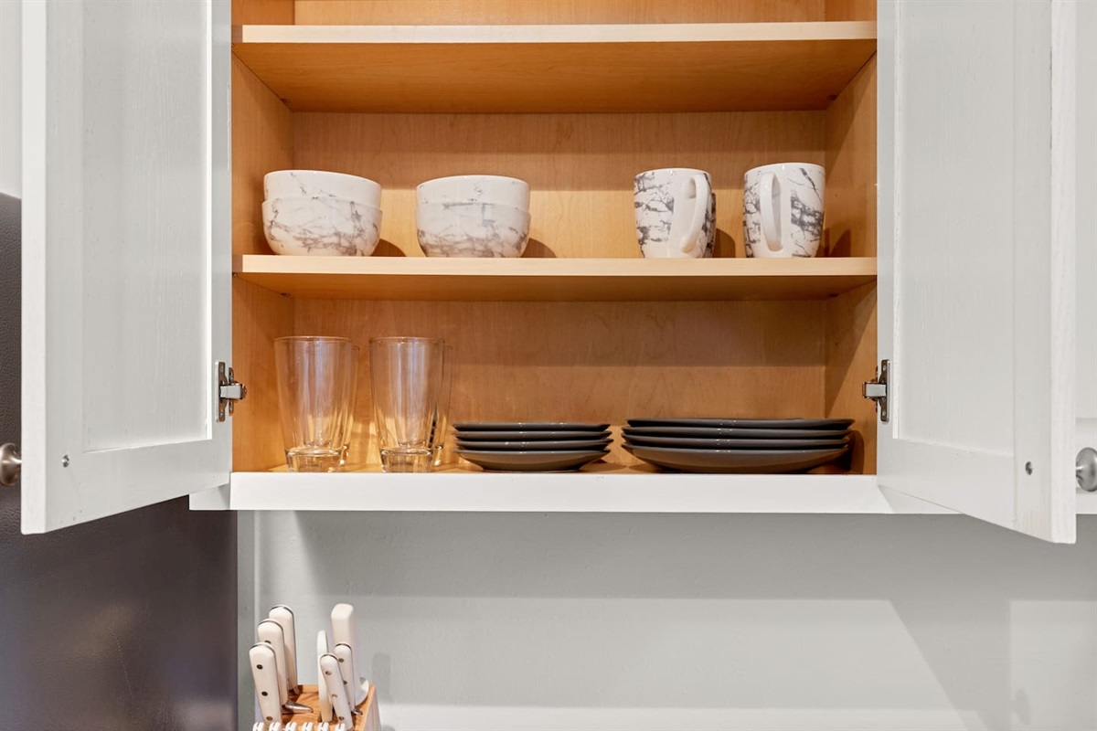 Our casita shelves are stocked with chic dinnerware and glasses, perfect for sharing meals and creating memories.