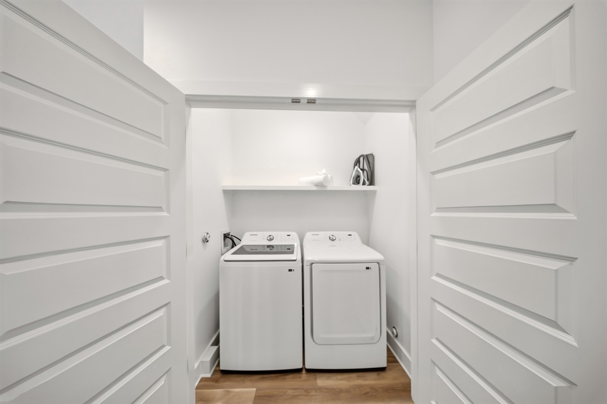 Laundry closet with washer and dryer for guest use