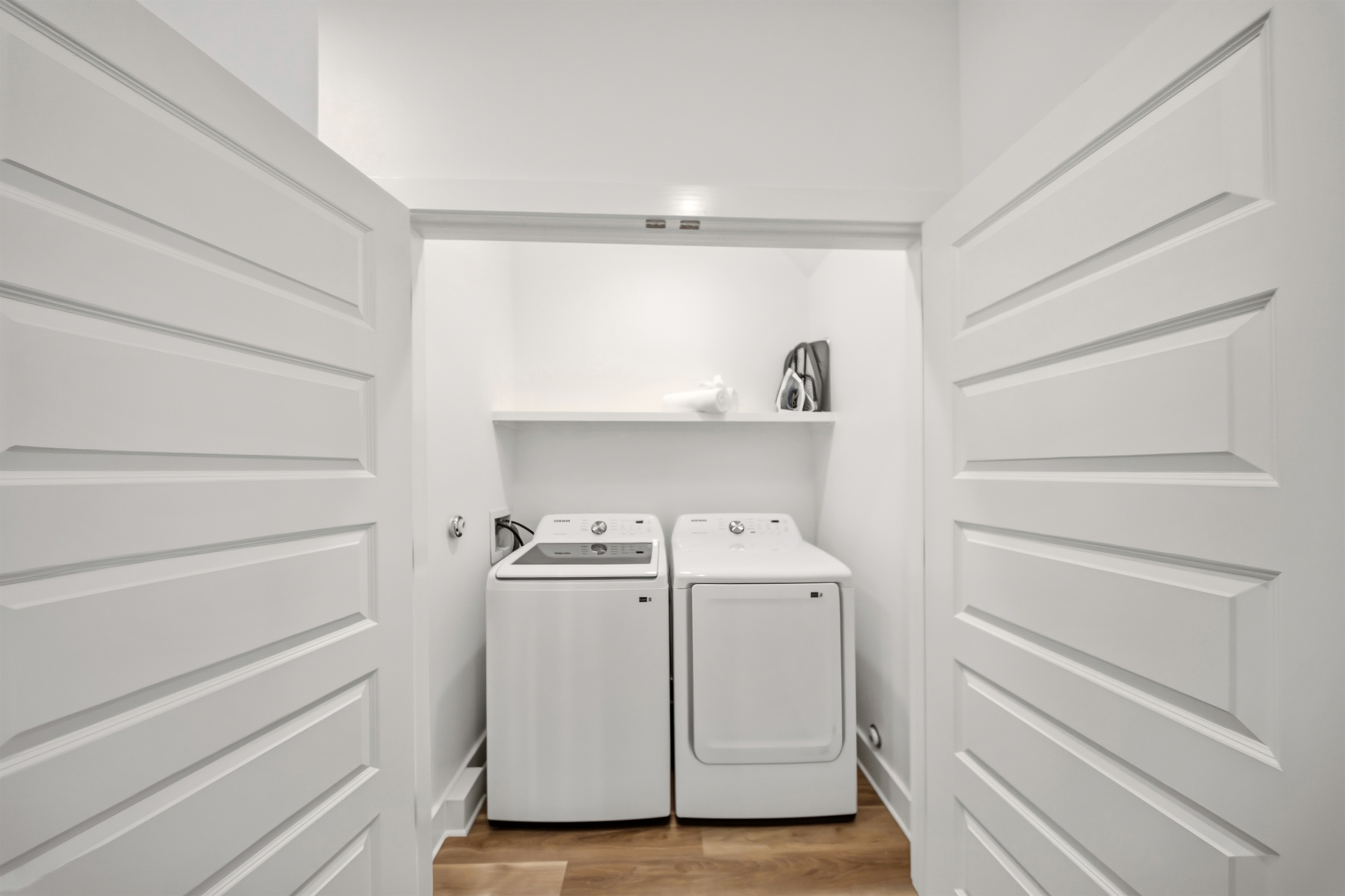 Laundry closet with washer and dryer for guest use