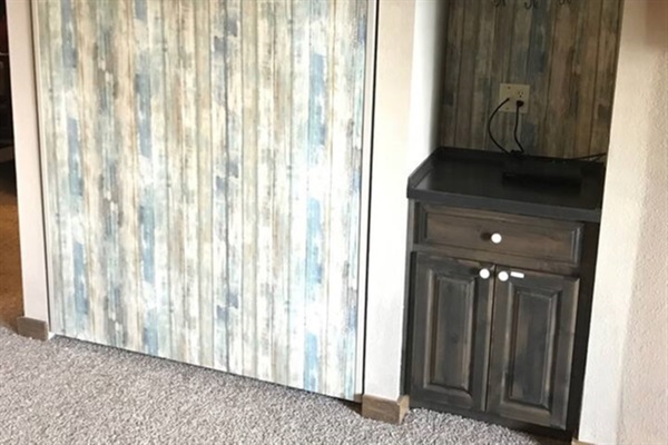 Full size Murphy Bed (up position) and Cabinet with books and games for your enjoyment