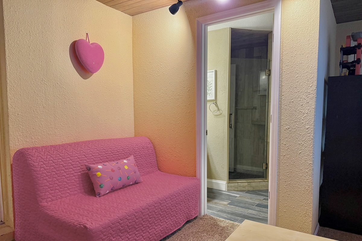Let the little ones burn off energy in this playful space equipped with a pink basketball hoop, indoor trampoline, and comfy sofa bed.