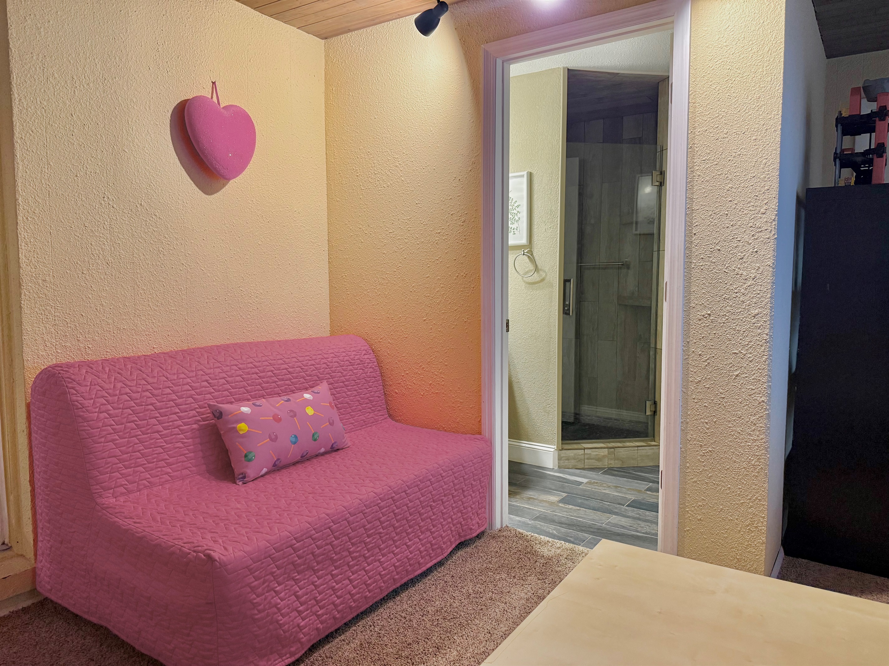 Let the little ones burn off energy in this playful space equipped with a pink basketball hoop, indoor trampoline, and comfy sofa bed.