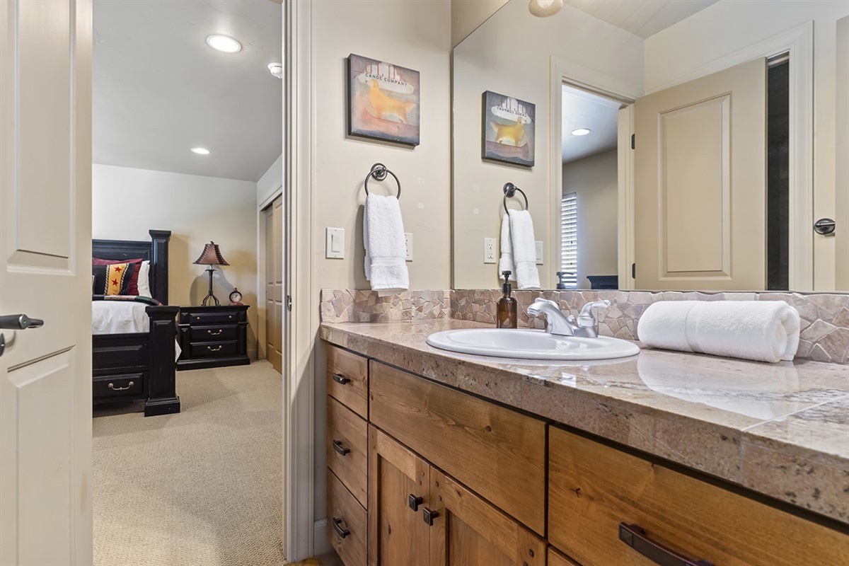 Convenient bathroom with a spacious vanity and direct access from the bedroom.