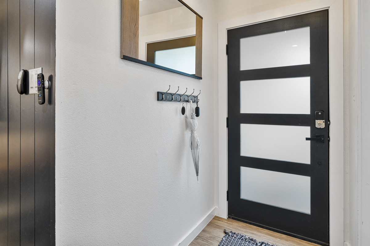 Stylish design with sleek door, chic mirror, and handy coat hooks for your Austin adventures!