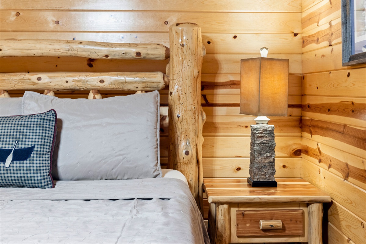 Bedroom 1 alternate view—warm lighting and cabin charm.