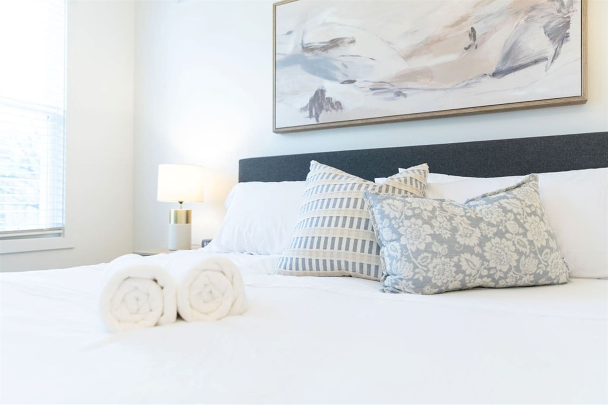 Zoomed-in view of the king-size bed with soft pillows, offering a cozy and inviting retreat.