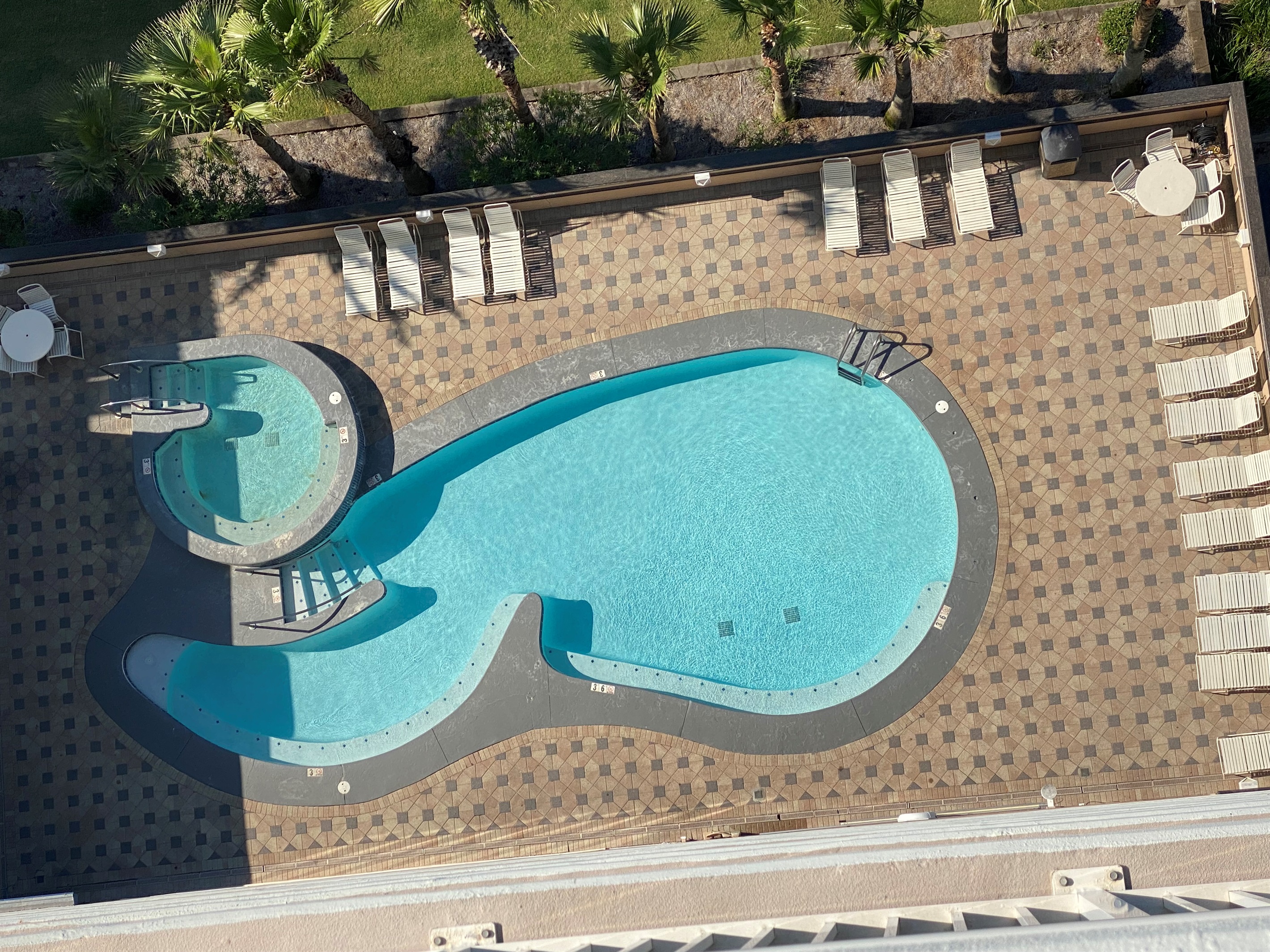 This beautiful outdoor pool and hot tub is located right across the street from the main building, offering a serene escape. Enjoy the convenience of access via our elevated, air-conditioned walkway, connecting you effortlessly to relaxation.