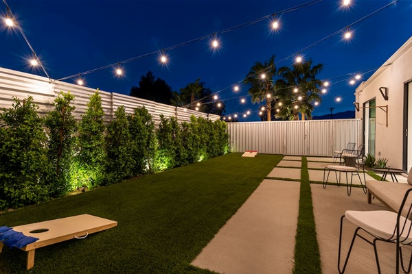 Outdoor game patio with string lighting for nighttime play