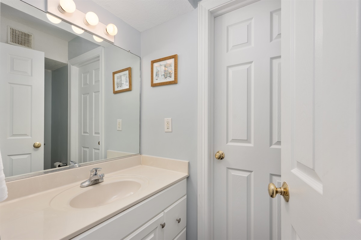 1st floor half bath and door that leads outside to the private pool, hot tub and tiki bar.