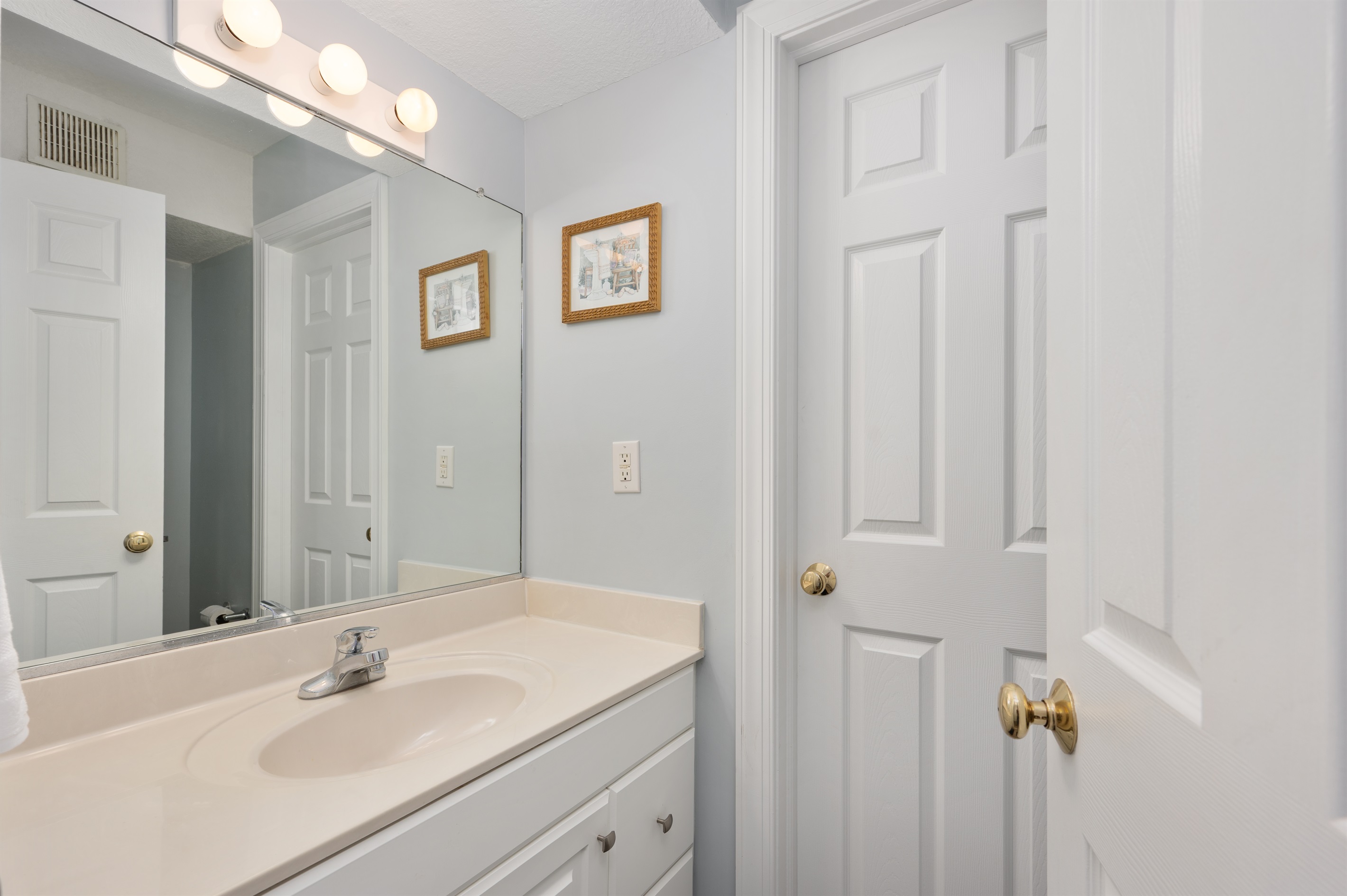 1st floor half bath and door that leads outside to the private pool, hot tub and tiki bar.