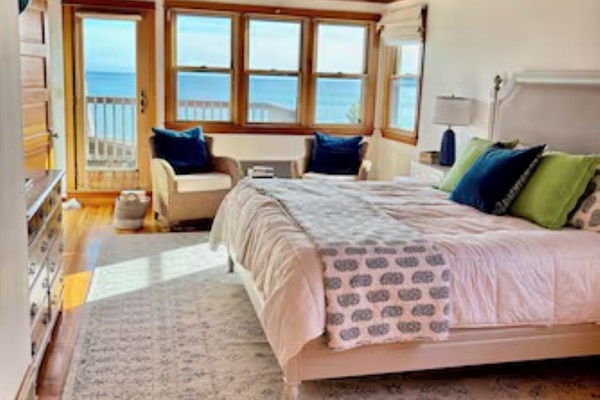 Bright coastal bedroom with stunning ocean views and private deck access, your perfect seaside retreat. 🌊