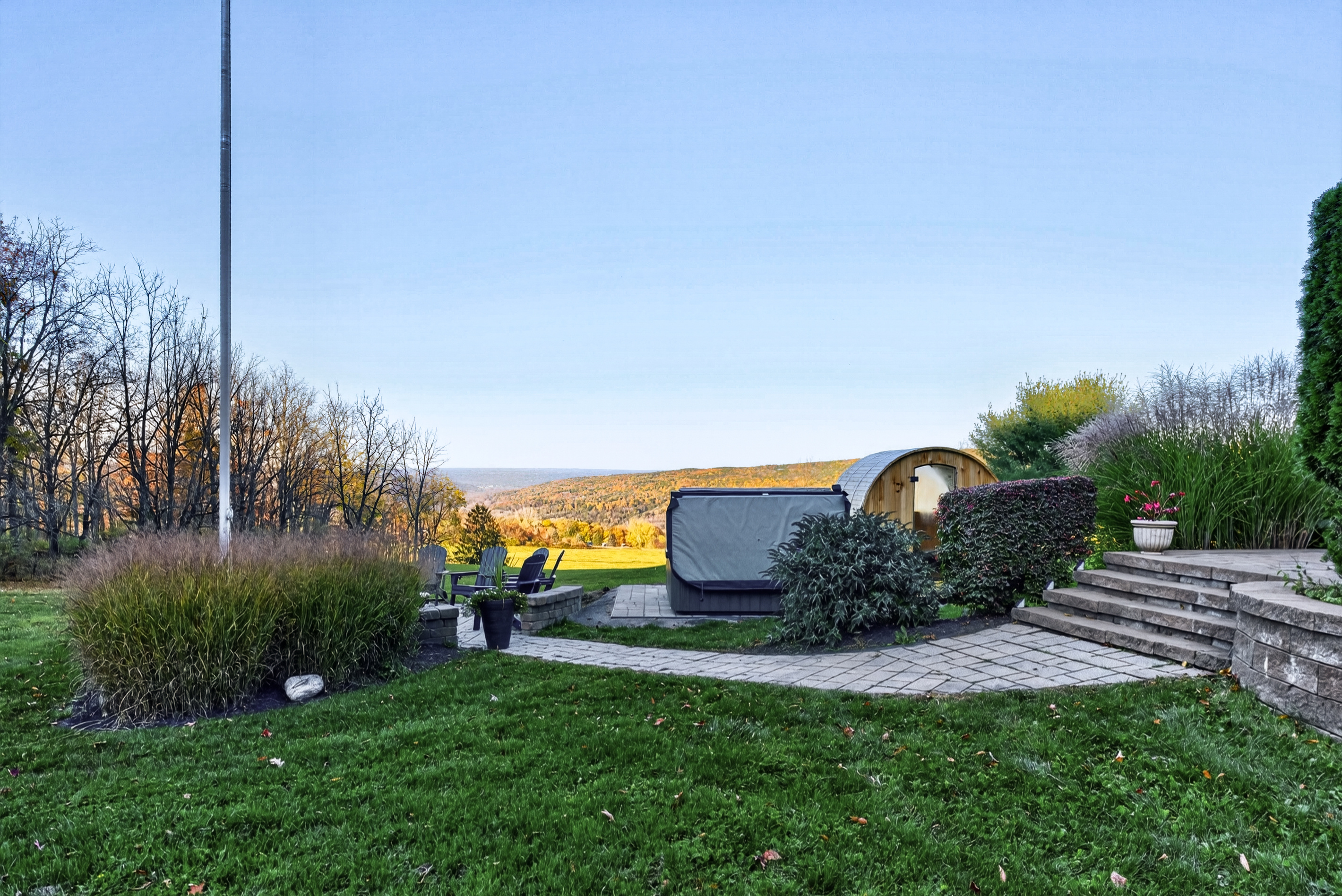 Landscaped backyard with sauna and stone steps