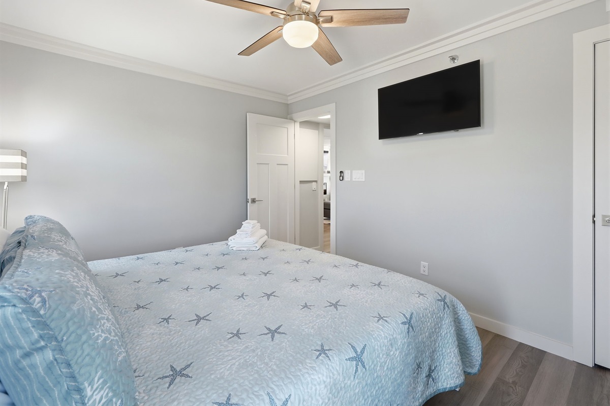 Unwind with a king bed, TV, and cozy coastal touches