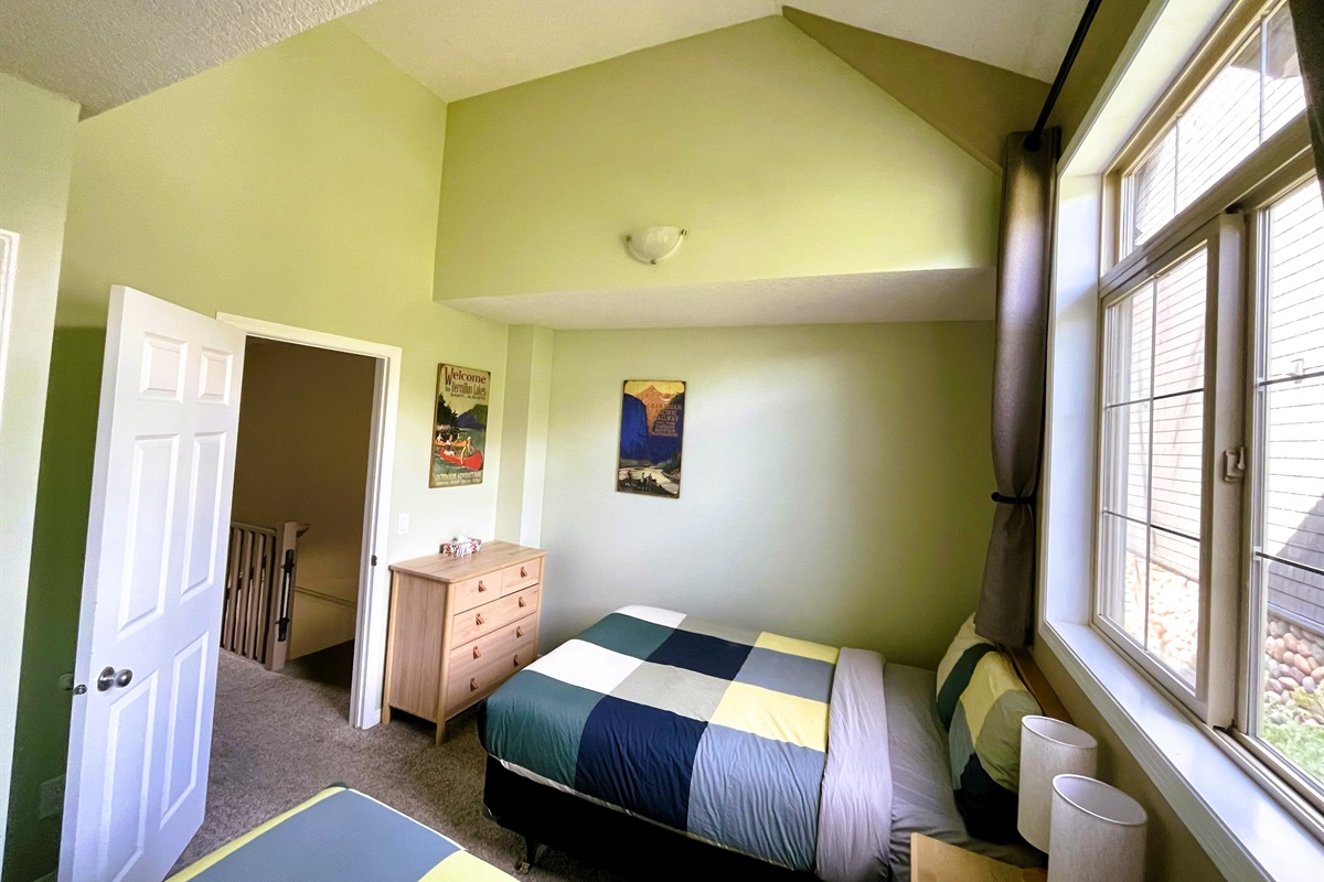 Guest bedroom with, two double beds. Vaulted ceilings and light blocking curtains. Adjacent bathroom in hallway. Located on 2nd floor.  