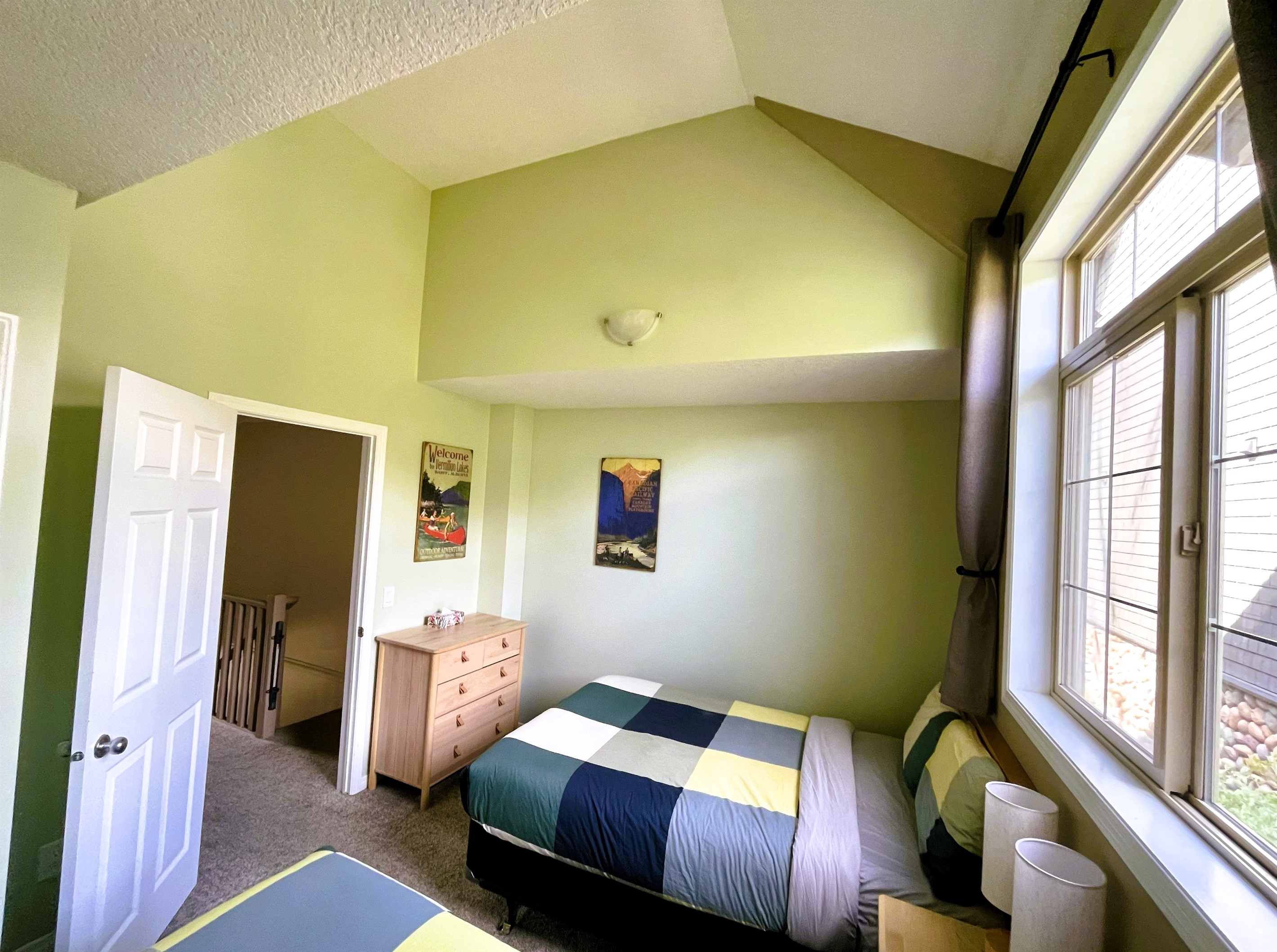 Guest bedroom with, two double beds. Vaulted ceilings and light blocking curtains. Adjacent bathroom in hallway. Located on 2nd floor.  