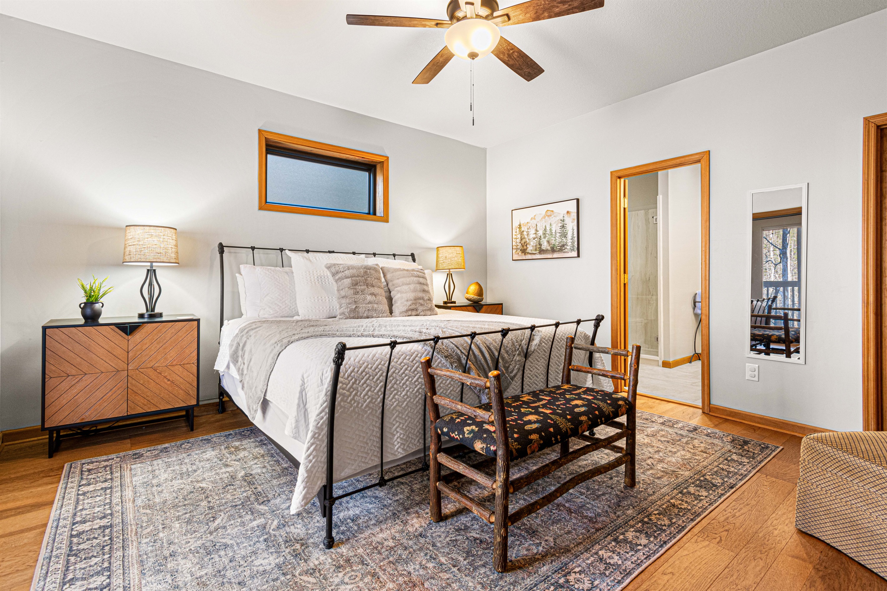 Downstairs King Bedroom, en-suite bathroom with shower and dual vanities,, 55" smart TV, and direct access to deck.