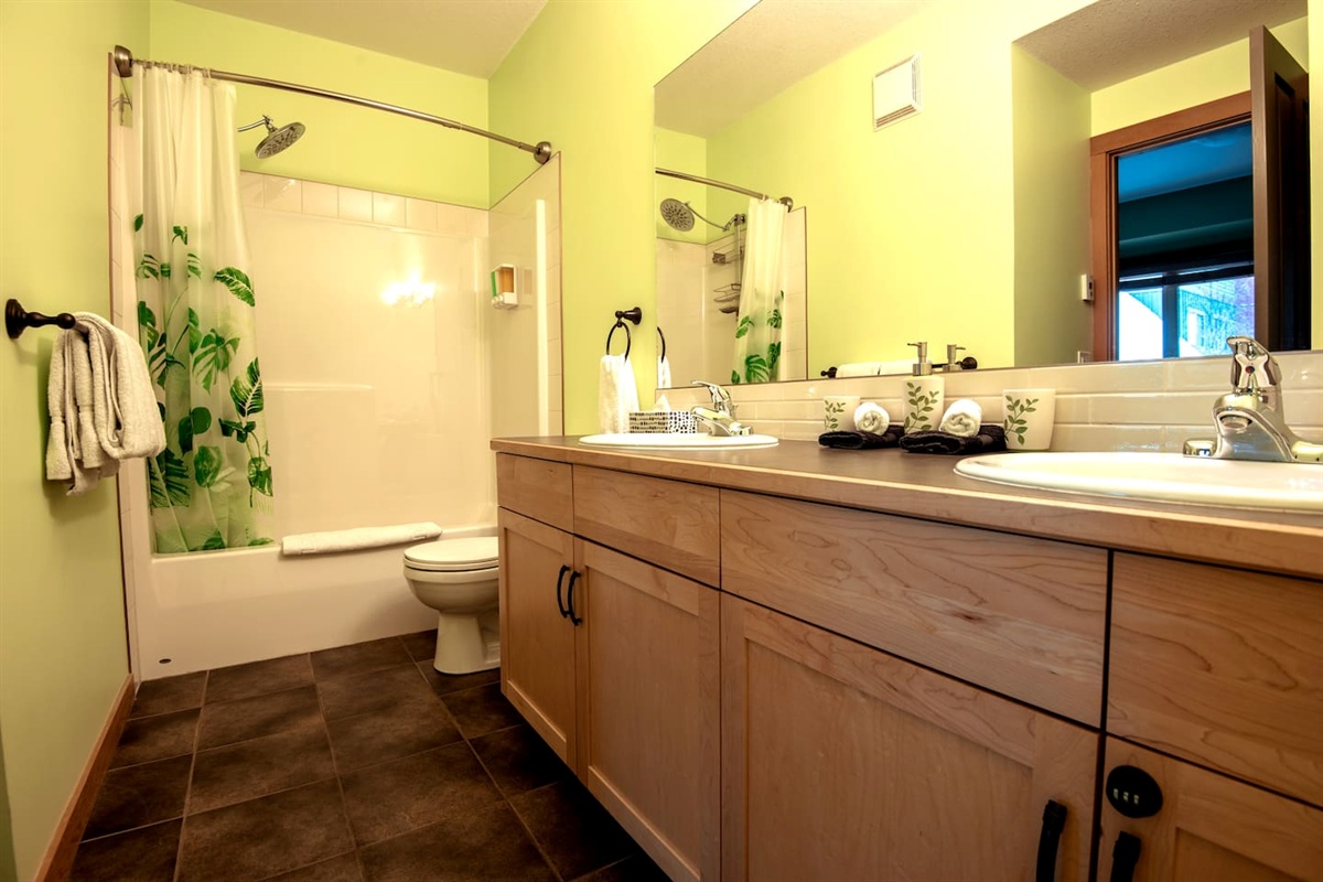 Master ensuite bathroom, with his and hers sink, shower, and tub.   Heated floor! 