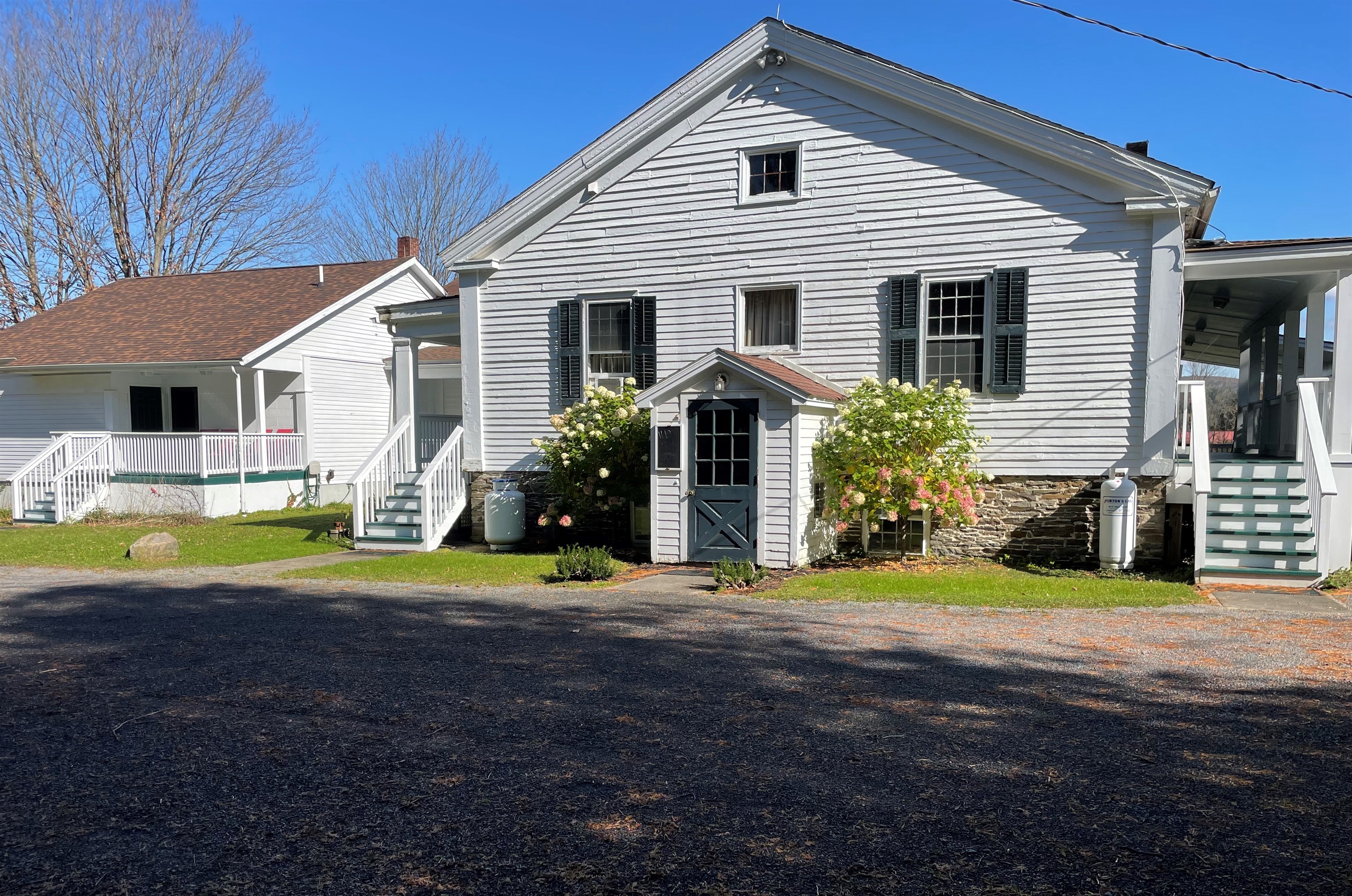 Exterior Tavern Entrance is the geen door in middle. Stairs on the right lead to Rooms 1 & 2. The stairs on the lead to room #3 & 4 and the far stairs on the left lead to rooms #5 & 6.