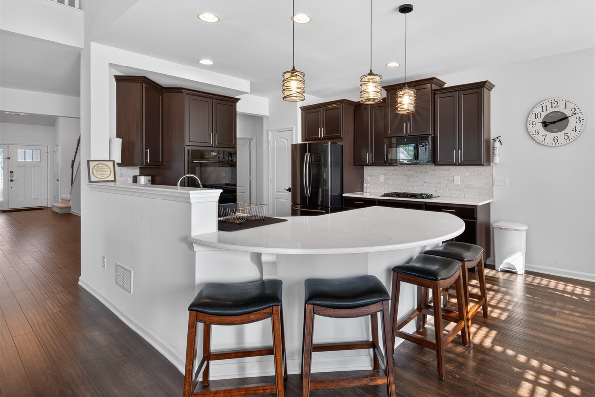 Quartz countertops, stainless steel appliances, gas cooktop, double oven, bottom freezer refrigerator, coffee maker, blender, toaster, full set of dishes, utensils, pots and pans