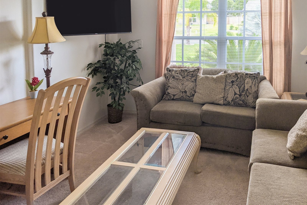 The Den with large screen TV and office desk.